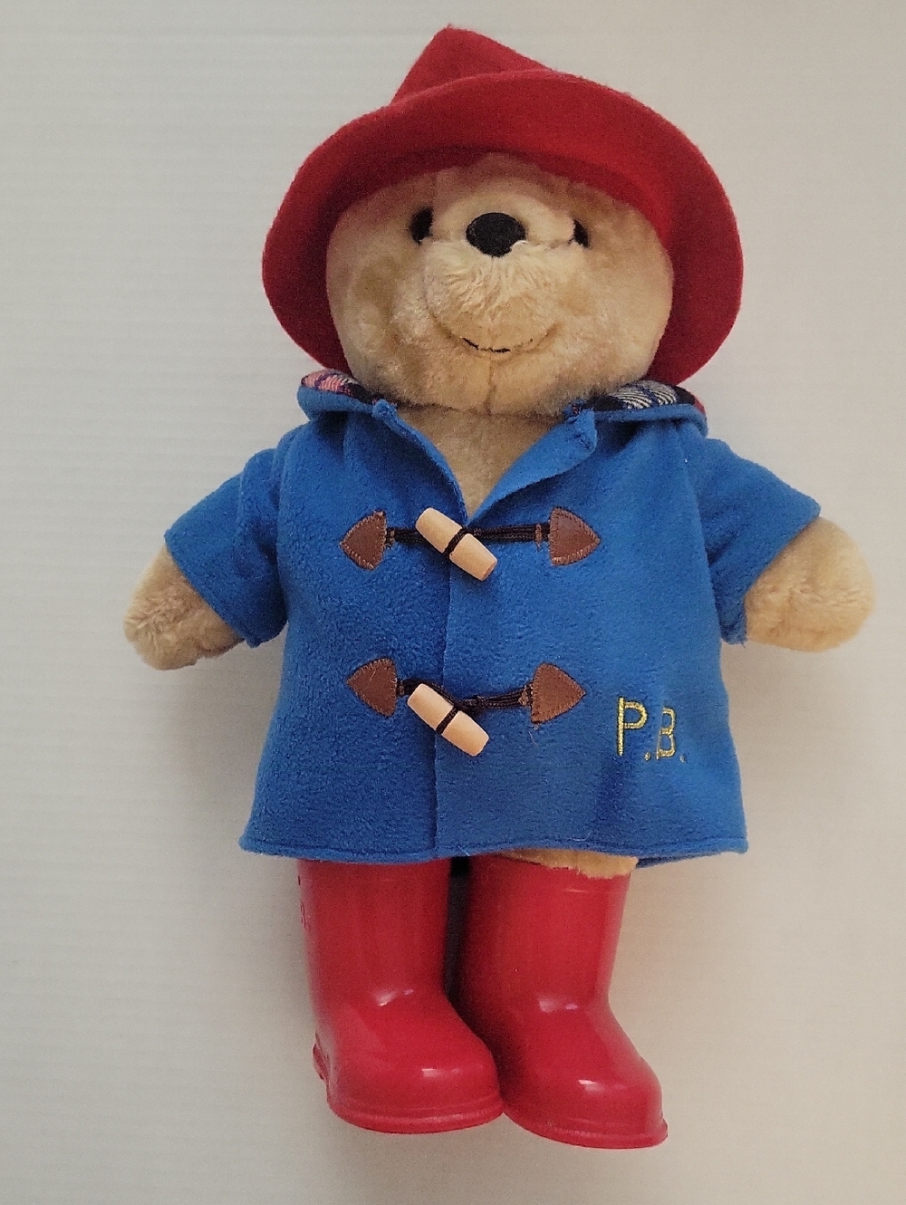 Paddington bear.Classic Beige Bear Plush in Blue Coat and Red Hat & Boots